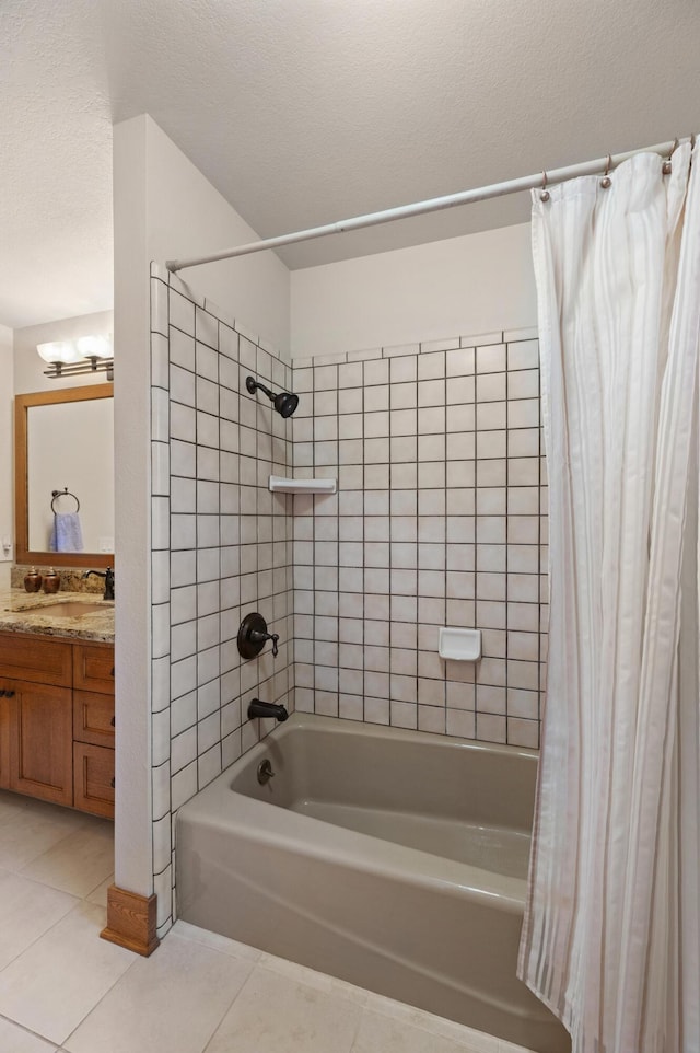 bathroom with a textured ceiling, tile patterned flooring, vanity, and shower / tub combo with curtain