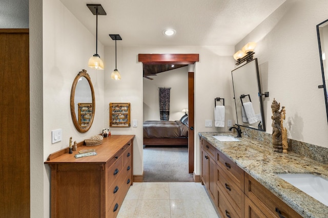 full bath featuring tile patterned flooring, connected bathroom, a sink, and double vanity