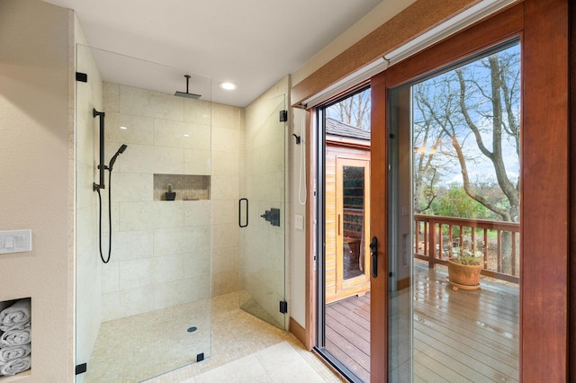 full bathroom featuring plenty of natural light and a shower stall