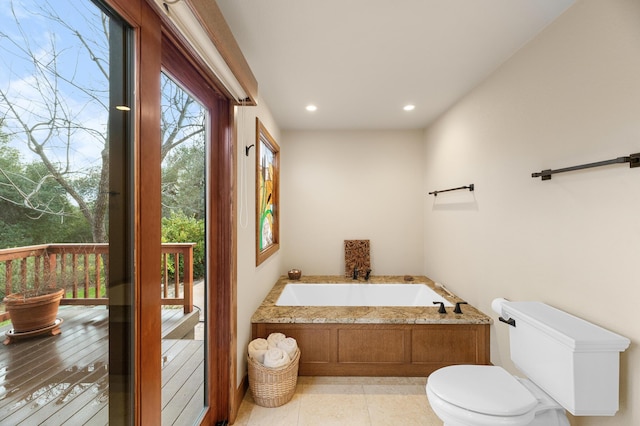 bathroom with recessed lighting, tile patterned flooring, a garden tub, and toilet