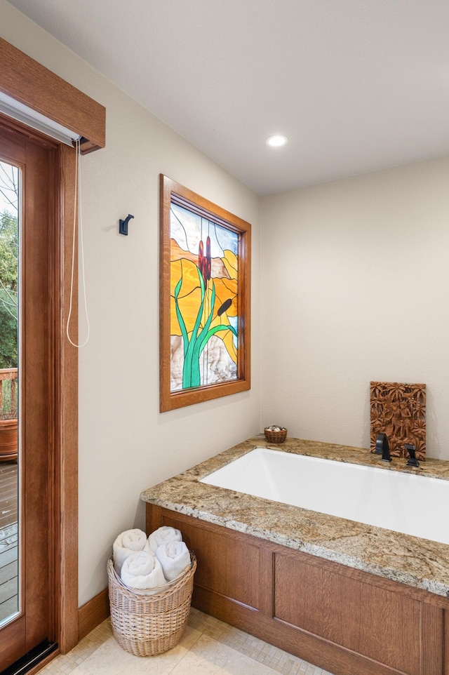 full bath with tile patterned flooring, baseboards, a bath, and recessed lighting