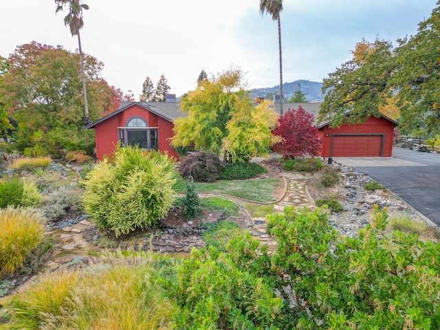 view of front of home with a garage and a mountain view