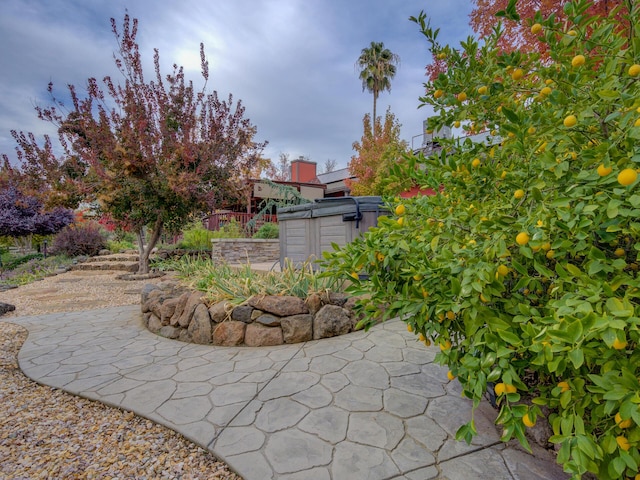 exterior space featuring a patio area and a hot tub