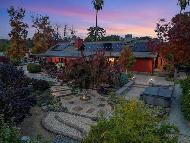 exterior space with solar panels and a patio