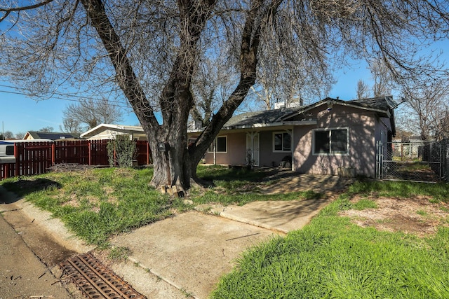 single story home with a gate and fence