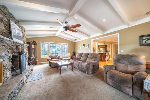 living room with carpet, a fireplace, visible vents, lofted ceiling with beams, and a ceiling fan