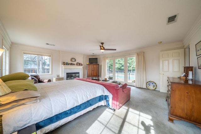 bedroom featuring multiple windows, visible vents, and light colored carpet