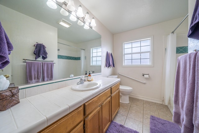 bathroom featuring curtained shower, baseboards, vanity, and toilet