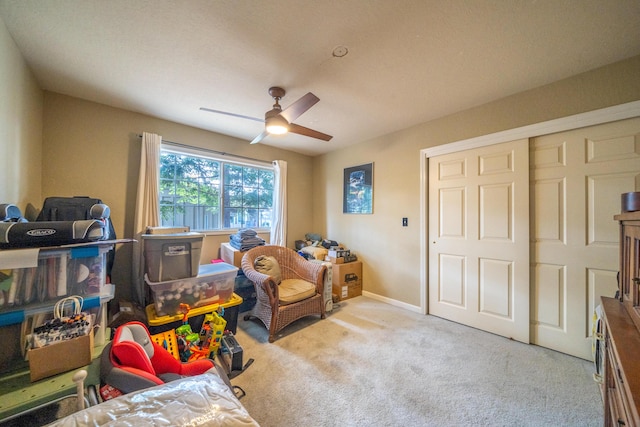 game room featuring light colored carpet, ceiling fan, and baseboards