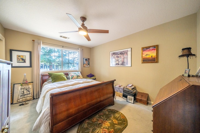 bedroom featuring light carpet, ceiling fan, and visible vents