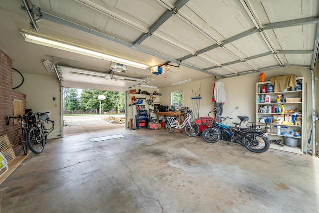 garage with a garage door opener and a workshop area