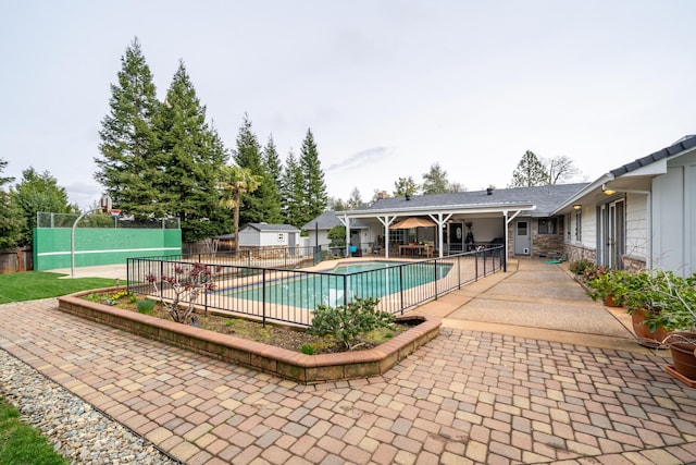 view of pool featuring a patio area, fence, and a fenced in pool