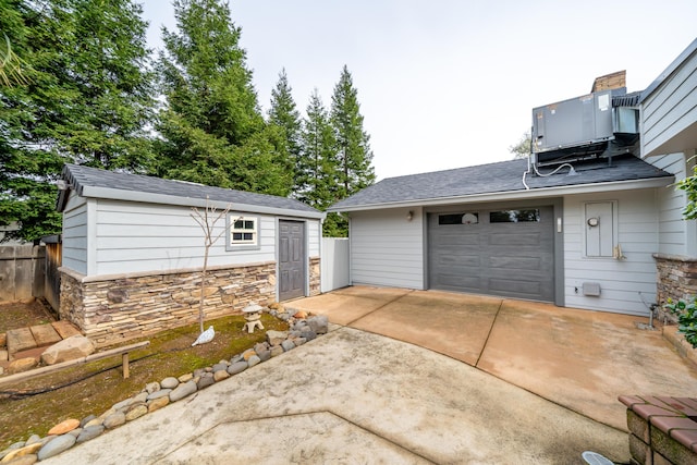 garage featuring driveway and cooling unit