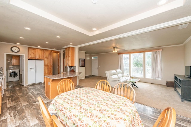 dining space featuring ceiling fan, washer / clothes dryer, and ornamental molding