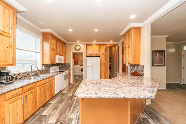 kitchen featuring white appliances, sink, separate washer and dryer, crown molding, and decorative backsplash