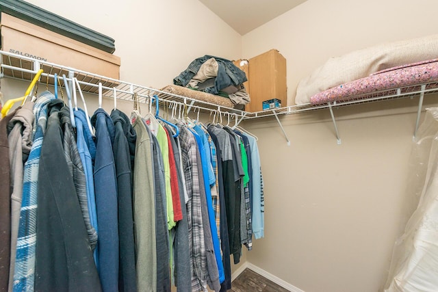 spacious closet featuring hardwood / wood-style flooring and lofted ceiling