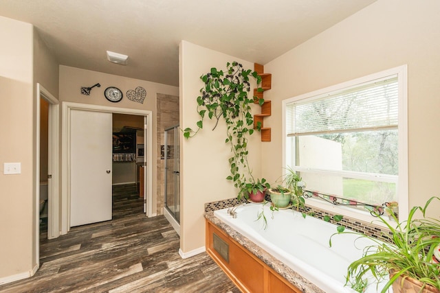 bathroom with separate shower and tub, toilet, and hardwood / wood-style flooring