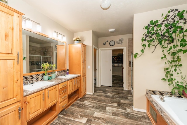 full bathroom featuring toilet, shower with separate bathtub, backsplash, hardwood / wood-style floors, and vanity