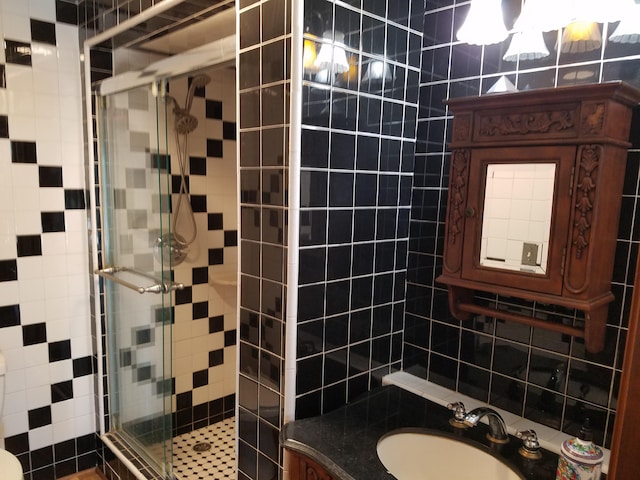 bathroom with a stall shower and vanity