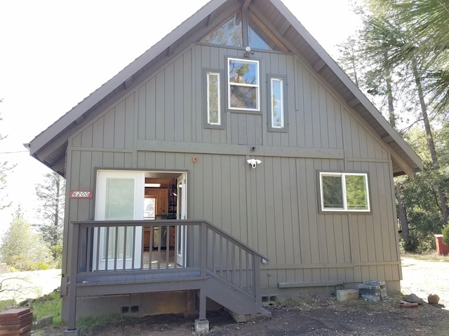 rear view of property featuring crawl space