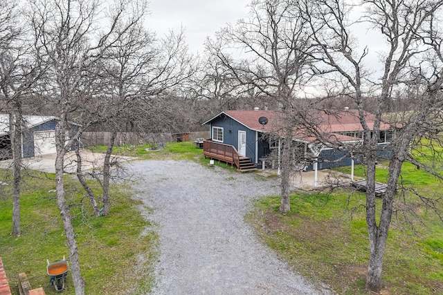 exterior space featuring a garage and a wooden deck