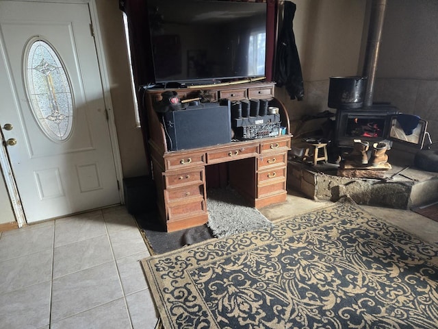 living room with light tile patterned floors and a wood stove