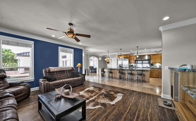 living room featuring ornamental molding, dark hardwood / wood-style floors, and ceiling fan