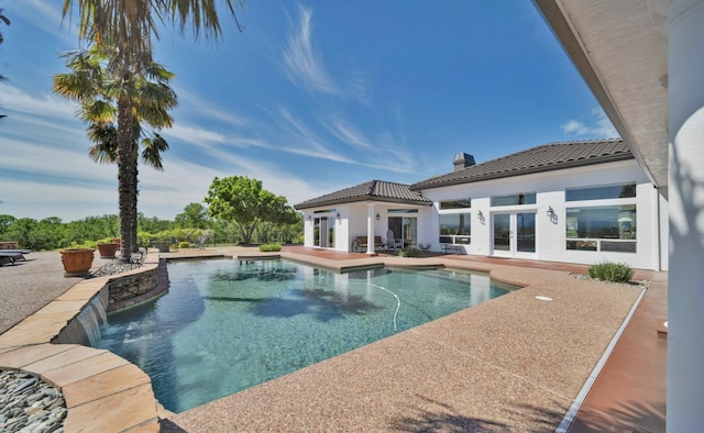 view of swimming pool featuring a patio, french doors, and pool water feature