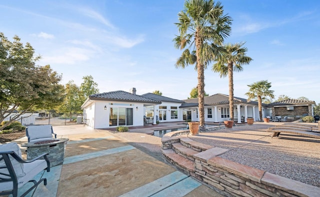 rear view of property with a patio and a fenced in pool