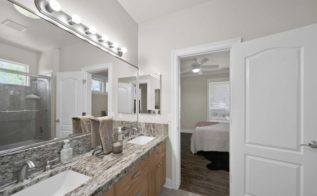 bathroom featuring vanity, hardwood / wood-style floors, shower / bath combination with glass door, and ceiling fan