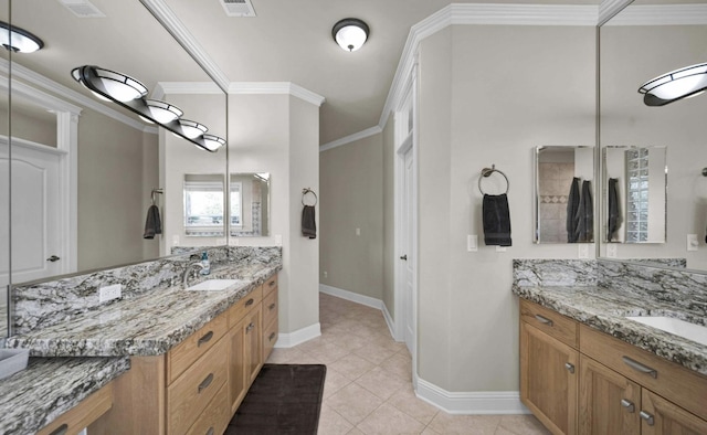 bathroom with vanity, ornamental molding, and tile patterned flooring