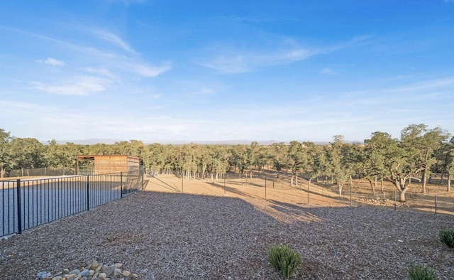 view of yard with a rural view and a pool