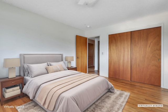 bedroom featuring light hardwood / wood-style flooring and a closet