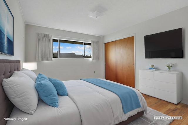 bedroom with a closet and light hardwood / wood-style floors