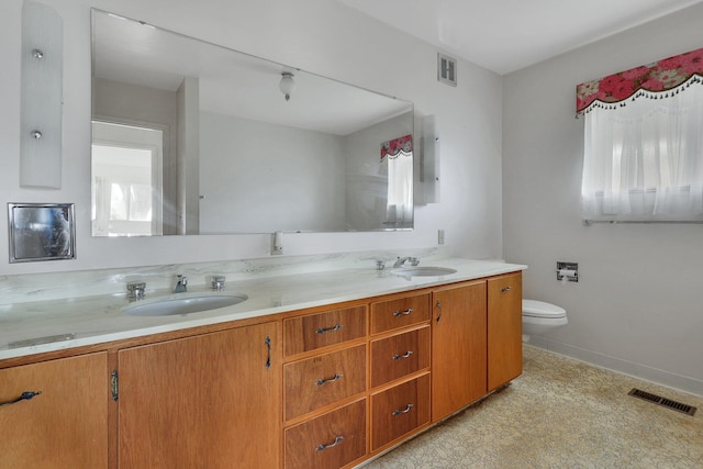 bathroom featuring toilet and vanity