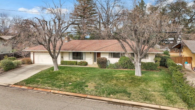 ranch-style home with a front yard and a garage