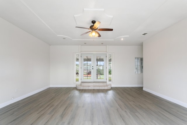 spare room featuring french doors, ceiling fan, and hardwood / wood-style flooring