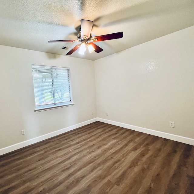 unfurnished room with ceiling fan, a textured ceiling, and dark hardwood / wood-style flooring