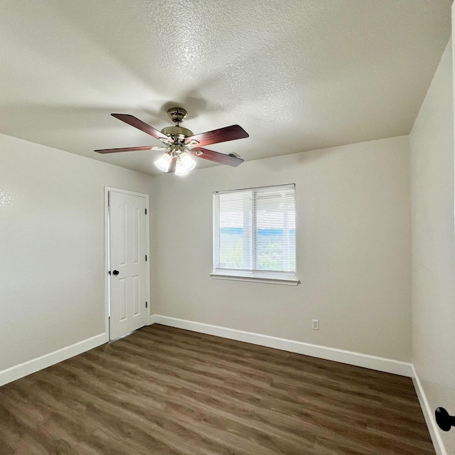 unfurnished room featuring a textured ceiling, dark hardwood / wood-style floors, and ceiling fan