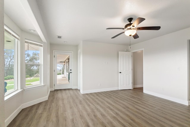 empty room featuring ceiling fan and wood-type flooring