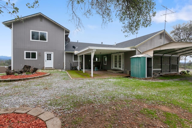 back of house with a yard and french doors