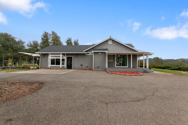 view of front facade with covered porch and a carport