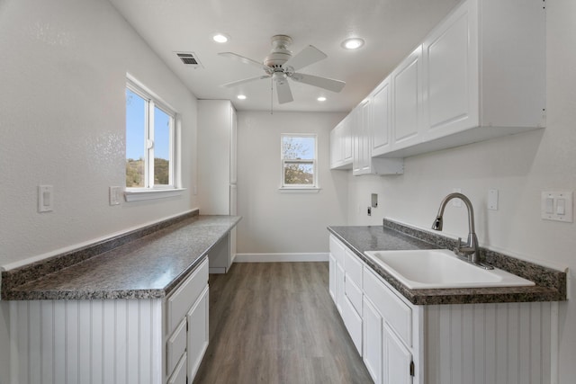 kitchen featuring sink, white cabinets, hardwood / wood-style floors, and ceiling fan