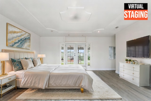 bedroom with french doors, access to outside, and dark hardwood / wood-style flooring