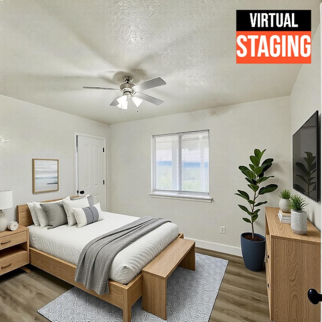 bedroom with a textured ceiling, hardwood / wood-style flooring, and ceiling fan