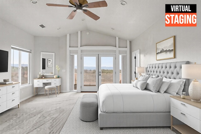 carpeted bedroom featuring multiple windows, access to exterior, high vaulted ceiling, and french doors