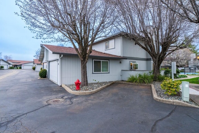 view of side of home with an attached garage