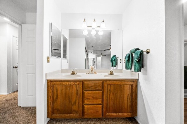 full bathroom with double vanity and a sink