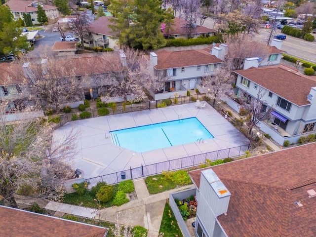 pool with fence and a residential view