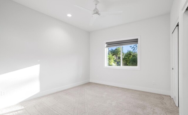 unfurnished bedroom featuring baseboards, a closet, recessed lighting, and light colored carpet